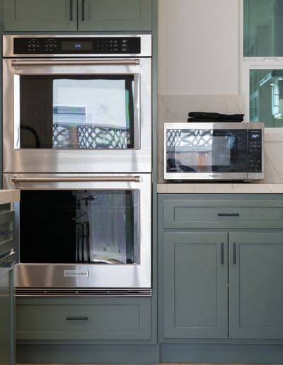 Stainless wall ovens set in sage green cabinets, San Jose, CA
