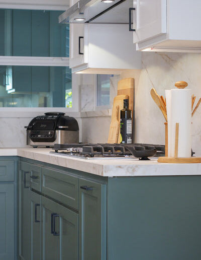 Sage green cabinetry around the cooktop, San Jose, CA