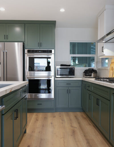 Sage green cabinets with stainless refrigerator and wall ovens, San Jose, CA