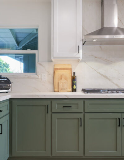 Sage green custom kitchen cabinets with range hood and window, kitchen remodel, San Jose, CA