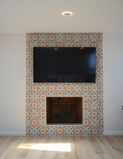 Fireplace with patterned tile surround and mounted TV, San Jose, CA